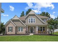 Charming two-story home featuring a brick and shingle facade with a covered porch and well-manicured lawn at 2118 Harmony Dr, Canton, GA 30115