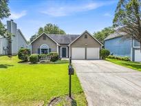 Charming single-story home with a well-maintained lawn and a two-car garage at 4517 Baker Grove Nw Rd, Acworth, GA 30101