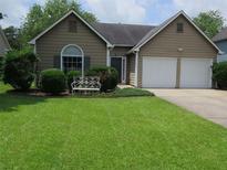 Charming single-story home with a well-manicured lawn and a two-car garage at 4517 Baker Grove Nw Rd, Acworth, GA 30101