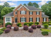Beautiful brick home featuring a landscaped front yard with lush greenery and charming curb appeal at 1360 Wilmington Way, Grayson, GA 30017