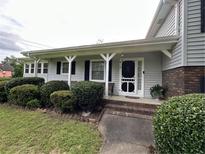 Charming home entrance featuring a brick walkway, well-manicured bushes, and a welcoming front door at 1610 Sprayberry Dr, Marietta, GA 30066