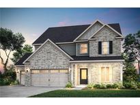 Charming two-story home featuring stone accents, a three-car garage, and professionally landscaped yard at 5220 Birch Valley Rd, Cumming, GA 30028