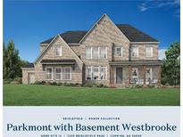 Beautiful two-story brick home with a covered front porch and a well-manicured lawn at 7220 Bridlefield Pass, Cumming, GA 30040