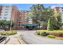 Apartment building exterior featuring a covered entrance and landscaped grounds at 2965 Pharr Nw Ct # 714, Atlanta, GA 30305