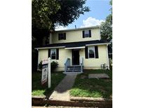 Charming two-story home features a symmetrical design, light yellow siding, and a welcoming entrance at 210 Ormond Sw St, Atlanta, GA 30315