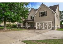Inviting two-story home features a spacious driveway and a charming two-car garage at 505 Mirror Lake Pkwy, Villa Rica, GA 30180