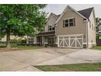 Charming two-story home with a two-car garage and a well-maintained front yard at 505 Mirror Lake Pkwy, Villa Rica, GA 30180