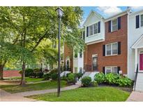Townhome with brick facade, black shutters, and landscaped front yard at 260 Manning Sw Rd # 76, Marietta, GA 30064