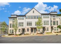Charming townhome with a combination of brick and siding facade and well-maintained landscaping at 2673 Caruso Way, Atlanta, GA 30339