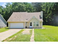 Charming single-Gathering home with a well-maintained lawn, driveway, and attached garage at 7073 Stonecreek Dr, Douglasville, GA 30134
