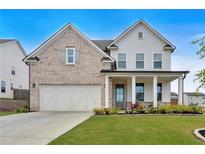 Charming two-story home with a brick and siding facade, well-manicured lawn, and an attached two-car garage at 87 Rushing View Gln, Dallas, GA 30157