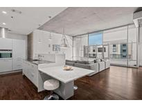 Contemporary open-concept kitchen featuring stainless steel appliances, marble countertops, and breakfast bar seating at 845 Spring Nw St # Ph 5, Atlanta, GA 30308
