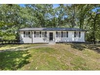 Charming, single-story home with a freshly painted white brick exterior and a well-maintained lawn at 4890 Old Briar Trl, Douglasville, GA 30135