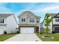 Charming two-story home with a brick-accented facade, well-manicured lawn, and a two-car garage at 149 Woodhouse Cir, Acworth, GA 30102
