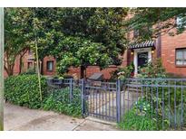 Charming brick building with lovely landscaping and a wrought iron fence and front garden at 330 3Rd St # Apt 1, Atlanta, GA 30308
