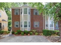 Attractive brick townhouse with well-maintained landscaping, providing a welcoming and comfortable living environment at 4149 Spring Cove Dr, Duluth, GA 30097