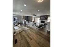 Bright living room with fireplace, wood-look floors, and lots of natural light at 3421 Fawn Trl, Marietta, GA 30066
