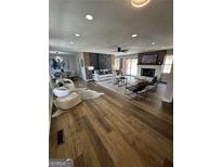 Open-concept living room with fireplace, hardwood floors, and lots of natural light at 3421 Fawn Trl, Marietta, GA 30066