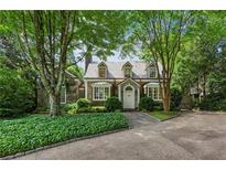 Charming stone and wood home with beautiful landscaping and a well-maintained front yard at 240 Nacoochee Nw Dr, Atlanta, GA 30305