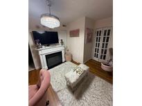 Cozy living room with fireplace, fluffy rug, television, and unique light fixture at 314 3Rd Ne St # 4, Atlanta, GA 30308