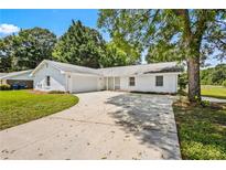 Charming one-story home with a long driveway, mature trees, and a well-maintained lawn at 1698 Brandy Woods Se Trl, Conyers, GA 30013