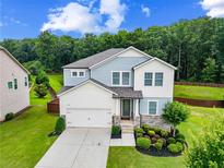 Charming two-story home featuring a two-car garage and beautifully landscaped front yard at 3735 Hazel Ave, Cumming, GA 30040