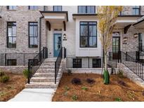 Charming brick townhome with well-manicured front yard and welcoming entry stairs at 550 Fisher Dr # 47, Alpharetta, GA 30009