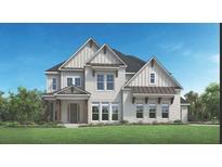 Beautiful two-story home featuring white brick, dormers and a well-manicured lawn at 3010 Florence St, Cumming, GA 30041
