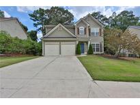 Charming two-story home with a well-maintained lawn and attached two-car garage at 5891 Buckner Creek Dr, Mableton, GA 30126