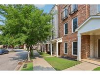 Charming brick townhouse with landscaped yard and sidewalk entrance at 761 Liberty Commons Nw Dr, Atlanta, GA 30314