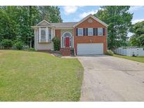 Charming two-story home with brick and siding, well-manicured lawn, and a two-car garage at 1010 San Marcos Cv, Lawrenceville, GA 30043