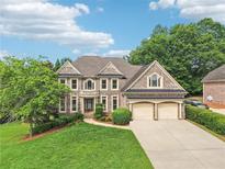 Charming brick two-story home featuring an attached two-car garage and landscaped front yard at 4508 Meadow Vista Trce, Lithonia, GA 30038