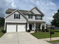 Charming two-story home featuring a two-car garage and landscaped front yard at 98 Concord Pl, Hiram, GA 30141