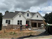 New construction home featuring white siding, brick accents, and an attached two-car garage at 202 Willow St, Canton, GA 30114