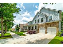 Charming two-story home featuring a stone facade, two-car garage, and a welcoming front porch at 9117 Hanover St, Lithia Springs, GA 30122