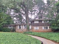 Charming two-story brick home with mature trees and lush ground cover in a tranquil setting at 1236 S Shadygrove Ct, Stone Mountain, GA 30083