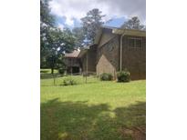 Brick home showing the backyard with a chain link fence at 1195 Christian Circle, Conyers, GA 30013