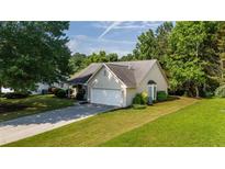 Charming single-Gathering home with well-maintained lawn and attached two-car garage at 5832 Sycamore Ridge Dr, Sugar Hill, GA 30518