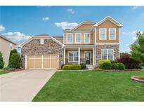 Charming two-story home with stone accents, a manicured lawn and a welcoming front porch at 506 Spring View Dr, Woodstock, GA 30188