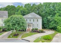 Charming two-story home with a landscaped front yard and driveway in a well-maintained neighborhood at 1223 Gathering Oaks Se Ct, Mableton, GA 30126