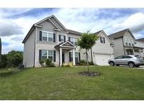 Charming two-story home with a combination of white brick and gray siding, accented by dark shutters at 3332 Grace Farm Ln, Buford, GA 30519