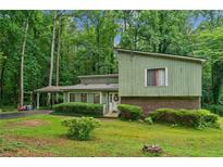 Charming two-story home with a large front yard and mature trees providing ample shade at 480 Pineburr Ln, Stone Mountain, GA 30087
