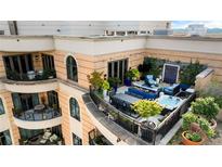 Expansive rooftop terrace featuring dining and seating areas, a hot tub, and lush landscaping at 3286 Northside Nw Pkwy # Ph2, Atlanta, GA 30327
