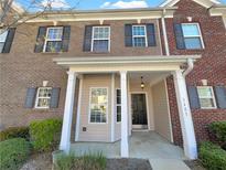 Charming brick townhome with inviting covered porch and well-maintained landscaping at 2555 Flat Shoals Rd # 3405, Atlanta, GA 30349