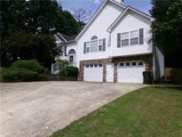 Charming two-story home with white siding, stone accents, two-car garage, and a well-maintained front yard at 49 Brinkley Ct, Dallas, GA 30157