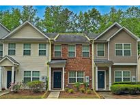 Charming townhome with a brick facade, well-maintained landscaping, and inviting curb appeal at 440 Berckman Nw Dr, Lilburn, GA 30047