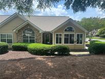 Inviting home featuring well-maintained landscaping, complemented by stone accents and large windows for ample natural light at 2191 Rockbridge Road # 2603, Stone Mountain, GA 30087