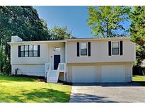 Charming two-story home featuring a well-manicured lawn, two-car garage, and inviting front porch at 2478 Wood Meadows Sw Dr, Marietta, GA 30064