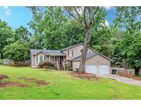 Charming home with a well-maintained front yard, beautiful tree, and inviting front porch at 252 Parkway Ct, Dallas, GA 30157