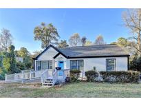 Charming single-story home with white brick, black trim, a bright blue door, and accessible ramp at 2502 Tupelo Se St, Atlanta, GA 30317